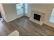 Bright living room with wood floors, a fireplace, and large windows at 4348 Sable St, Denver, CO 80239