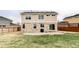 Spacious backyard with green grass, stone patio and wood fence at 24505 E Wagon Trail Ave, Aurora, CO 80016