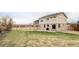Spacious backyard with green grass, stone patio and wood fence at 24505 E Wagon Trail Ave, Aurora, CO 80016
