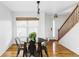 Sunlit dining room featuring hardwood floors and a contemporary chandelier at 24505 E Wagon Trail Ave, Aurora, CO 80016