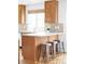 Stylish kitchen featuring wooden cabinetry and a functional breakfast bar at 24505 E Wagon Trail Ave, Aurora, CO 80016