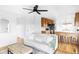 Open-concept living room featuring a kitchen area and a sleek ceiling fan at 24505 E Wagon Trail Ave, Aurora, CO 80016