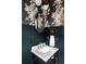 Stylish powder room with floral wallpaper, marble countertop, and gold fixtures at 24505 E Wagon Trail Ave, Aurora, CO 80016