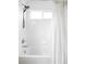 Clean shower and tub with white tile, shower curtain and window at 24505 E Wagon Trail Ave, Aurora, CO 80016