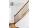 Classic staircase with wooden railing and white walls, illuminated by natural light at 24505 E Wagon Trail Ave, Aurora, CO 80016