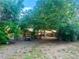 Lovely backyard with mature trees, sitting area, and wooden fence at 19156 E Arizona Pl, Aurora, CO 80017