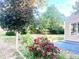 A serene backyard blends natural beauty with outdoor living, showcasing rose bushes near patio at 19156 E Arizona Pl, Aurora, CO 80017