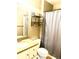 Cozy bathroom with essential fixtures, including a sink, toilet, and shower with a curtain at 19156 E Arizona Pl, Aurora, CO 80017