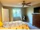 Comfortable bedroom featuring a ceiling fan, ample natural light, and plush carpet at 19156 E Arizona Pl, Aurora, CO 80017
