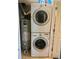 A stacked washer and dryer set located near a water heater at 19156 E Arizona Pl, Aurora, CO 80017