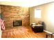 Cozy living room features a brick fireplace and hardwood floors at 19156 E Arizona Pl, Aurora, CO 80017