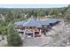Beautiful aerial view of a sprawling home nestled in a lush, wooded landscape at 17548 Colonial Park Dr, Monument, CO 80132
