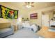 Cozy bedroom features a sitting area, ceiling fan, and stylish decor at 17548 Colonial Park Dr, Monument, CO 80132