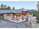 Stunning front exterior showcasing stone accents, covered porch, manicured landscaping, and an inviting circular driveway at 17548 Colonial Park Dr, Monument, CO 80132