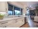 Bright kitchen with modern countertops, stainless steel dishwasher, and view to the outdoor patio at 17548 Colonial Park Dr, Monument, CO 80132
