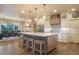 Bright, modern kitchen with a large island, stainless steel appliances, and a view of the dining area at 17548 Colonial Park Dr, Monument, CO 80132