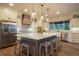 Spacious kitchen featuring a large island with seating, stainless steel appliances, and custom cabinetry at 17548 Colonial Park Dr, Monument, CO 80132