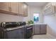 This laundry room features gray cabinets, and high-end appliances for an efficient and elegant laundry experience at 17548 Colonial Park Dr, Monument, CO 80132