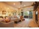 Open living room with a seamless flow to the kitchen, featuring stylish furnishings and an abundance of natural light at 17548 Colonial Park Dr, Monument, CO 80132