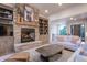 Inviting living room with a stone fireplace, built-in shelving, comfortable seating, and an open layout at 17548 Colonial Park Dr, Monument, CO 80132