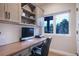 Functional home office featuring built-in shelving, a spacious desk, and a large window with outdoor views at 17548 Colonial Park Dr, Monument, CO 80132