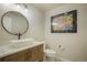 Modern powder room features a vessel sink, stylish vanity, and contemporary artwork at 17548 Colonial Park Dr, Monument, CO 80132
