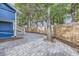 Rear patio area with stone pavers, and a newly constructed wooden fence surrounding the backyard at 1519 16Th St, Boulder, CO 80302