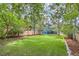 Expansive backyard with lush lawn, new wooden fence, mature trees, and neighboring home views at 1519 16Th St, Boulder, CO 80302