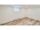 Finished basement with hardwood floors, a window, and a baseboard heater at 1519 16Th St, Boulder, CO 80302