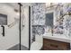 Stylish bathroom featuring blue floral wallpaper, glass shower and designer fixtures at 1519 16Th St, Boulder, CO 80302