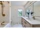 Modern bathroom with double vanity, marble floors, and tiled shower with gold hardware at 1519 16Th St, Boulder, CO 80302