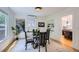 Elegant dining room with a glass table, built-in shelves, and a view into the kitchen at 1519 16Th St, Boulder, CO 80302