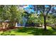 Charming blue home exterior with green lawn, mature trees, and a newly installed wood fence at 1519 16Th St, Boulder, CO 80302
