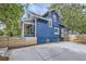 Exterior of a blue home with a white porch, fenced yard, and a concrete patio at 1519 16Th St, Boulder, CO 80302