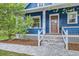 Inviting blue home with a craftsman-style wood front door, decorative lattice, and stone path at 1519 16Th St, Boulder, CO 80302