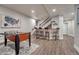 Finished basement features foosball table, bar area, and stairway at 2948 S Clarkson St, Englewood, CO 80113