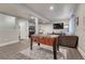 Finished basement with a foosball table, TV, and comfortable seating area provides a great entertaining space at 2948 S Clarkson St, Englewood, CO 80113