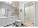 Stylish bathroom with white vanity, wood accent wall, and glass enclosed shower at 2948 S Clarkson St, Englewood, CO 80113