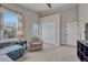 Neutral-toned bedroom with a ceiling fan, a cozy seating area and closet space at 2948 S Clarkson St, Englewood, CO 80113
