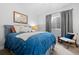 Bedroom features a blue bed, white pillows, and a window at 2948 S Clarkson St, Englewood, CO 80113