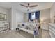 Comfortable bedroom with a ceiling fan, white metal bed frame, and blue curtains at 2948 S Clarkson St, Englewood, CO 80113