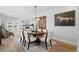 Elegant dining area featuring a modern chandelier, a round wooden table, and stylish decor at 2948 S Clarkson St, Englewood, CO 80113
