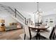Open-concept dining room features an ornate chandelier and staircase at 2948 S Clarkson St, Englewood, CO 80113