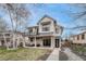Stunning two-story home with a covered porch, balcony, and modern farmhouse design elements at 2948 S Clarkson St, Englewood, CO 80113