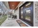 Inviting front porch with comfortable seating, stylish decor, and a modern front door at 2948 S Clarkson St, Englewood, CO 80113