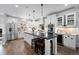 Bright kitchen featuring white cabinets, a center island with seating, and stainless steel appliances at 2948 S Clarkson St, Englewood, CO 80113