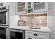 Elegant kitchen featuring glass cabinets, a beverage fridge, and stone countertops at 2948 S Clarkson St, Englewood, CO 80113