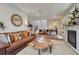 Spacious living room featuring a leather couch, unique coffee table, fireplace and an open floor plan at 2948 S Clarkson St, Englewood, CO 80113