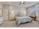 Large primary bedroom with custom headboard, bench seat and large windows at 2948 S Clarkson St, Englewood, CO 80113