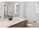 A stylish bathroom features a white countertop, modern sink fixtures and neutral paint at 8686 Pennycress Dr, Littleton, CO 80125